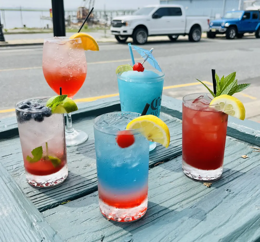 Colorful cocktails and beer on an outdoor table