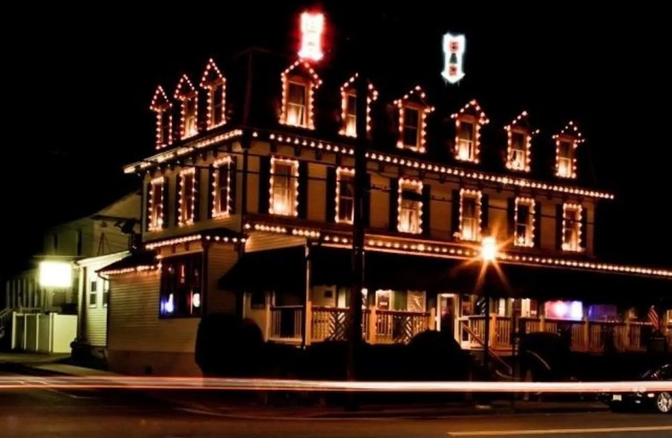 The Anchorage Tavern at night with its three-story front outlined in lights
